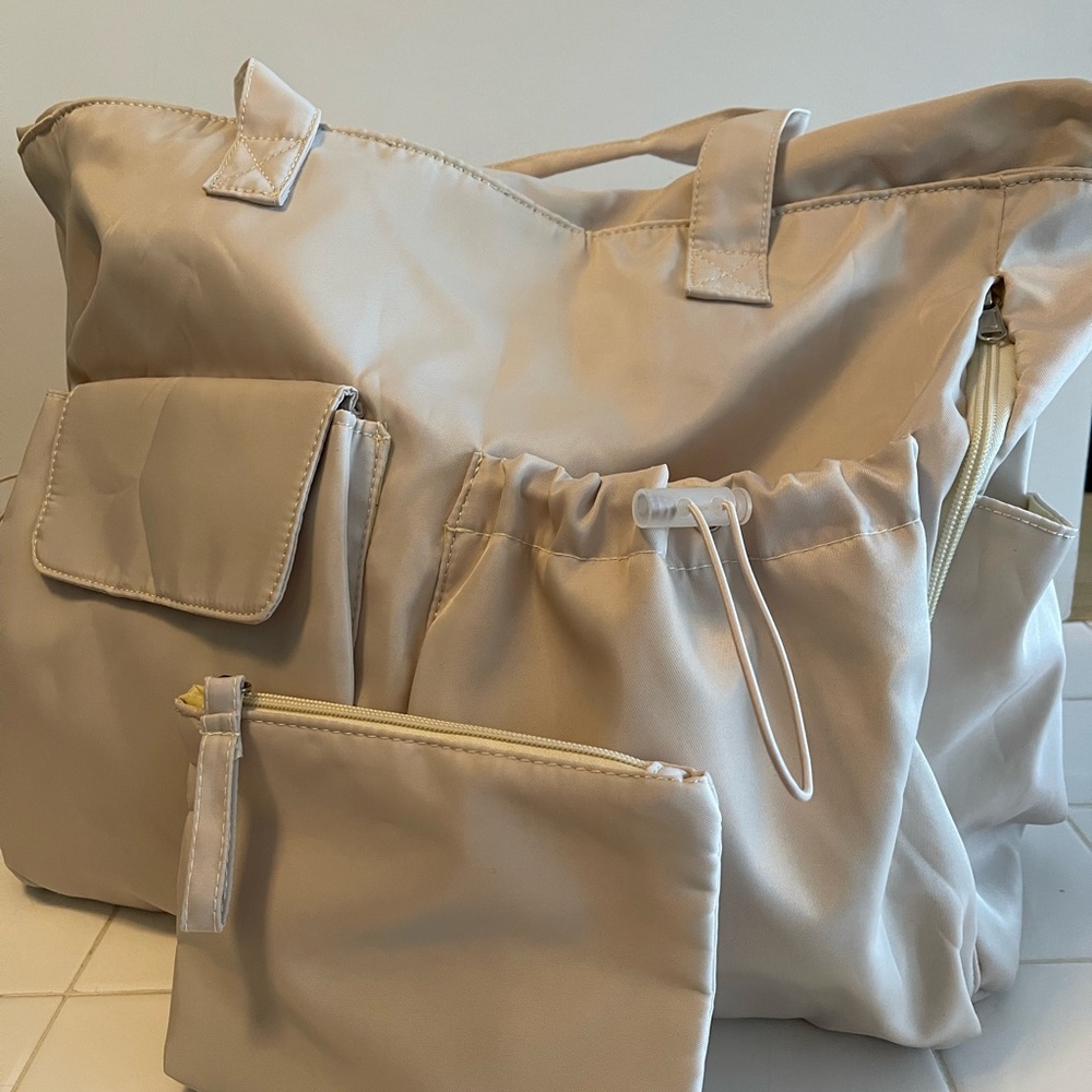 Cream colored weekender overnight bag.  New w/o tags